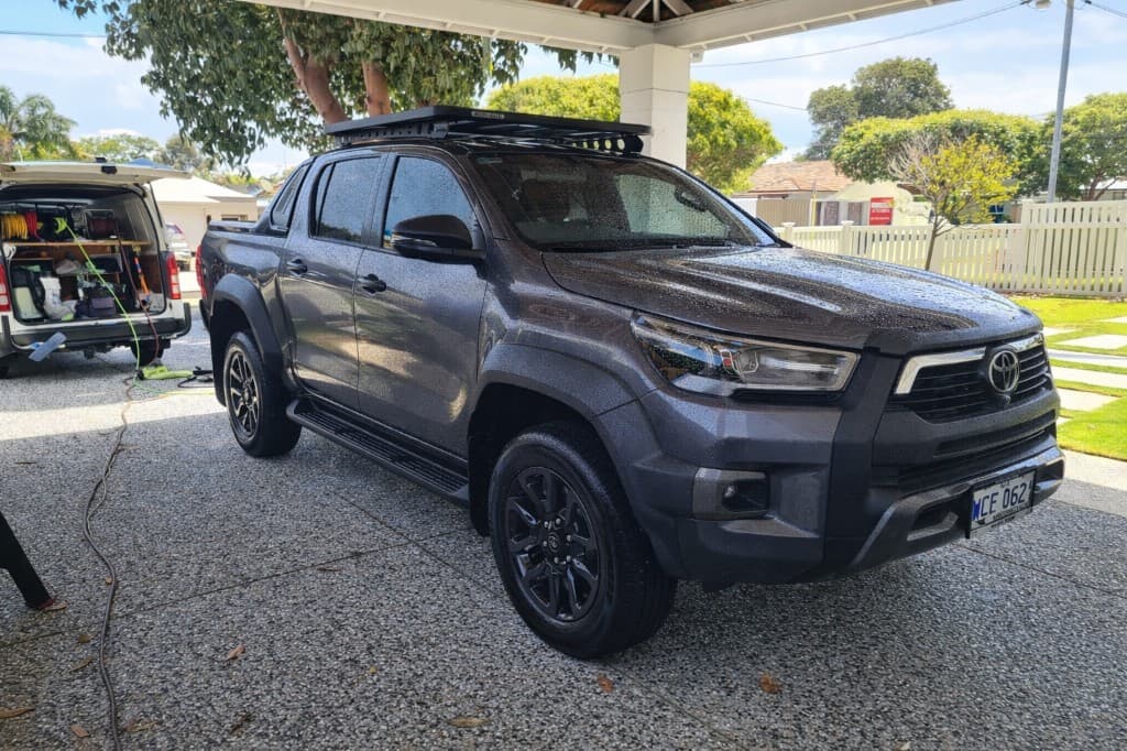 Mobile ceramic coating in Perth — Toyota Hilux with water beading after professional paint protection, Autobot Detailing van on site